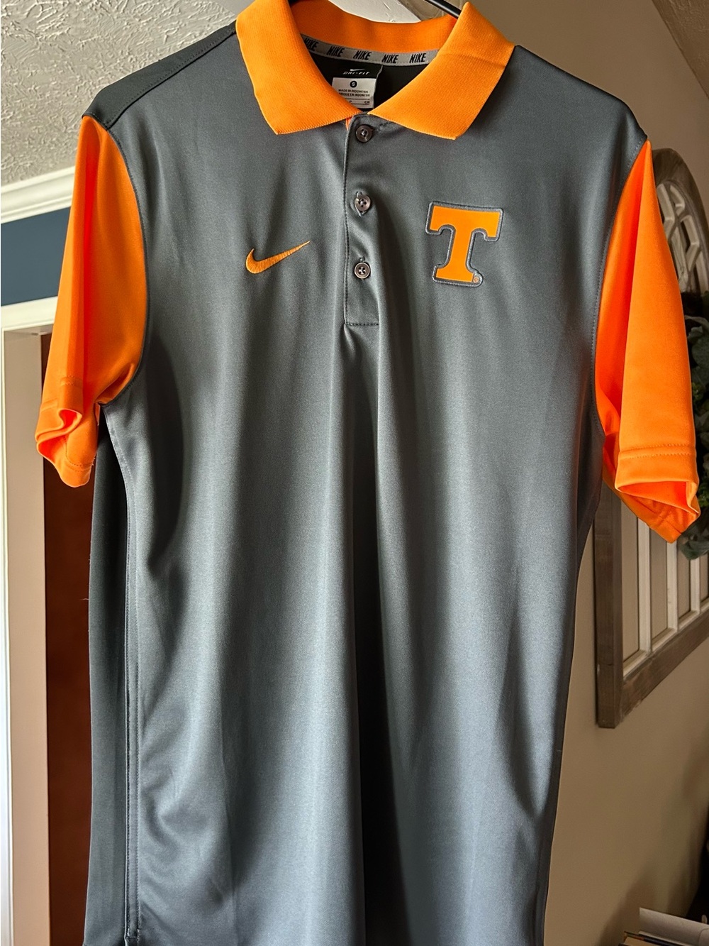 Nike men’s Gray Polo with Bright Orange Accents and 'T' Logo